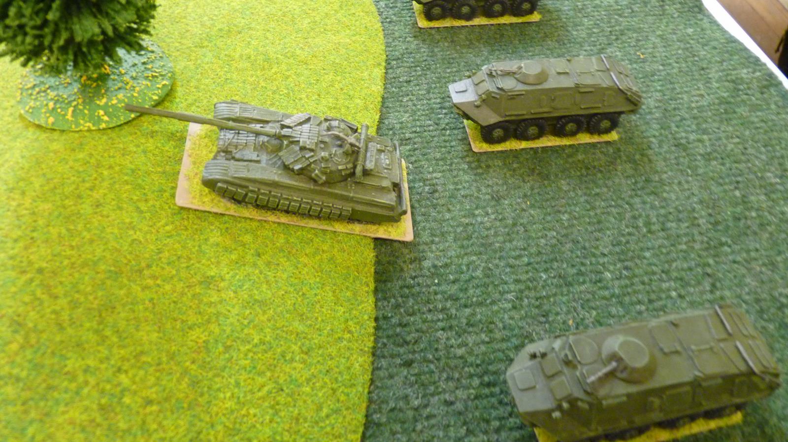 A T64 leads a Soviet platoon towards the village on the left flank.